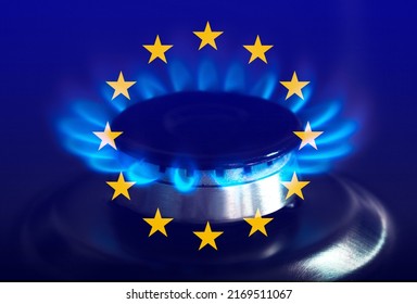 The blue flame of a gas stove in the dark. Gas burner on the background of the flag of the European Union. The concept of gas consumption in Europe - Shutterstock ID 2169511067