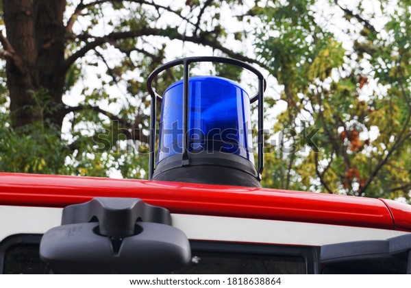blue\
flashing light on the roof of a fire truck close\
up