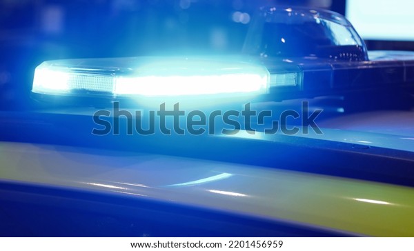blue flashing of police car siren during emergency\
at night