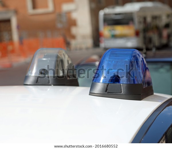 blue flashing siren of police car while patrolling\
the city