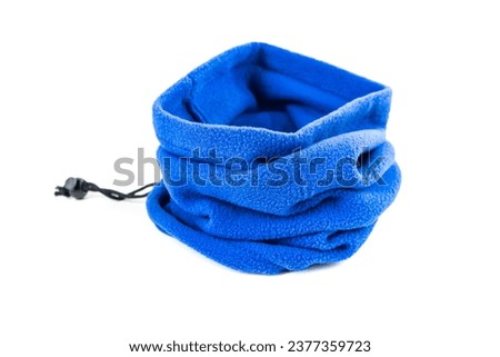 Blue fleece neck gaiter bunched up on a white background