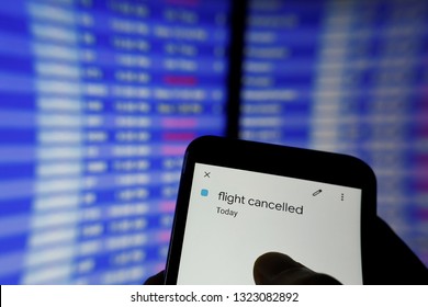 Blue Flight Schedule Screen At Airport. Typing Finger. Flight Cancelled Pop Up On Calendar Mobile. Cancel Flight, Booking And Insurance Concept. Business Travel And Holidays Corona Virus Cancellation