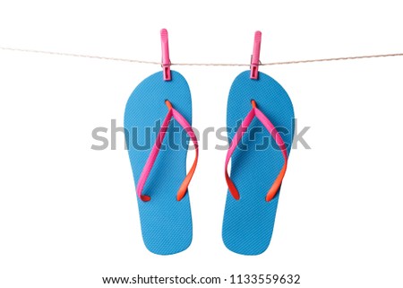 Blue flip flops hanging on clothesline isolated on a white background. Vacation concept