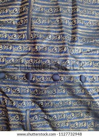 Blue flower embroidery button down shirt. close up.