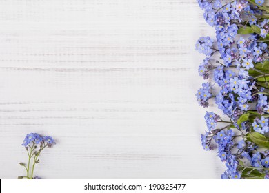 blue flowers on white wooden background