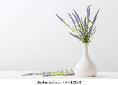 Blue Flowers In A Vase On White Background