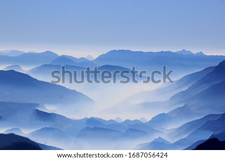 Similar – Landscape with sunset in blue mountains