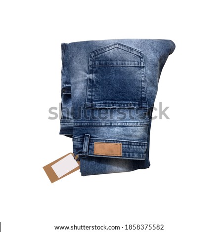 Blue folded denim jeans with lable and pricetag with white background