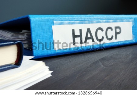 Blue folder with documents HACCP Hazard Analysis and Critical Control Points.