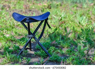 A Blue Folding High Chair For Camping On A Summer Green Glade