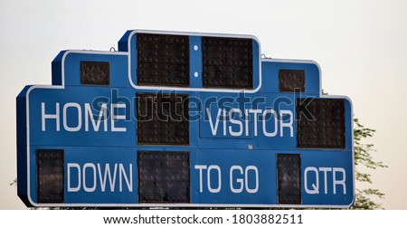 Blue football scoreboard on a football field