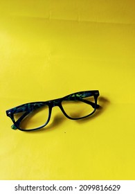 Blue Frame Glasses With Yellow Background
