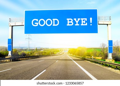 Blue Freeway Sign Over The Road On Sunny Day With Words Good Bye On It