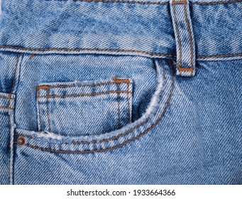 Blue front jeans pocket, old jeans close-up

