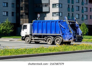 Blue Garbage Truck On The Street Of The City