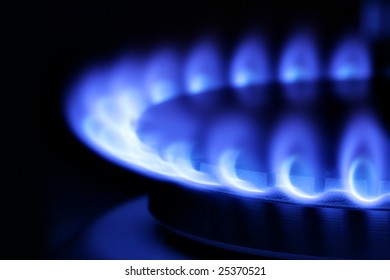 Blue Gas Flame On Hob Close Up In The Dark