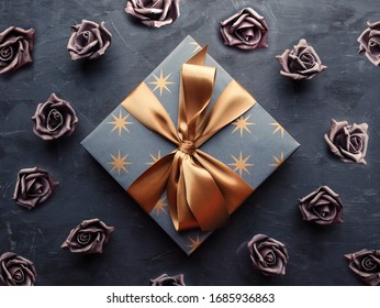 Blue Gift Box With Gold Ribbon Bow On Blue Background. Overhead Shot.