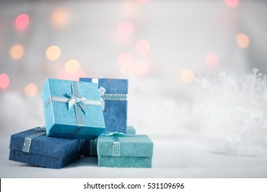 Blue gift boxes on the white fur with copy space for season greeting Merry Christmas or Happy New Year.