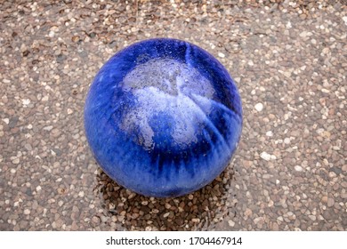 Blue Glass Sphere On Pebble Road