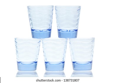 Blue Glass Stacked Shot Glasses On A White Background