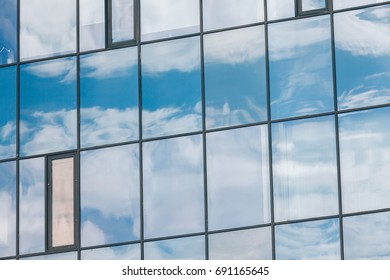 blue glass wall of office building with wooden decorative elements
