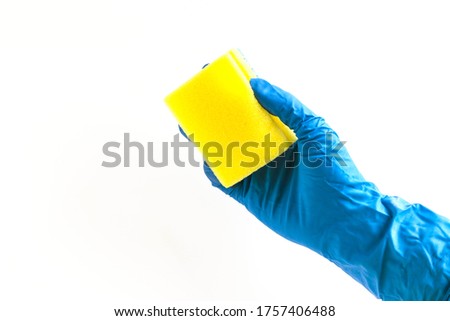 Blue glove for cleaning with yellow sponge. Isolated on a white background.