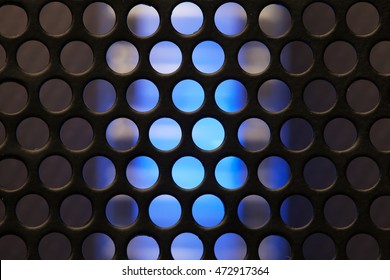 Blue Glow Of A High Performance Server, Operating Behind A Metal Mesh Or Grid. Abstract Background. Focus On Mesh Of Grid. Shallow Depth Of Field.