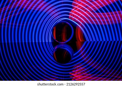 Blue Glowing Circles Around A Glass Sphere With Red Stripes