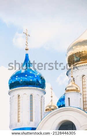 Blue and golden domes of white orthodox church