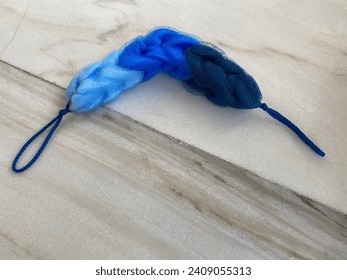 Blue gradient loofah on the marble floor - Powered by Shutterstock