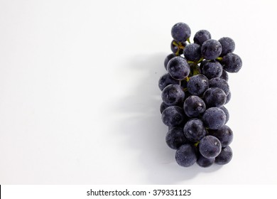 Blue Grapes Close Up On A White Background 