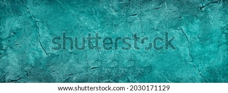 Blue green abstract background. Toned rock surface texture. Beautiful teal background with copy space for design. Wide banner.