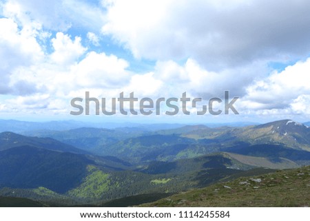 Blue and green amazing Carpathian mountains with clouds in background. Concept of nature landscapes.