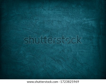  Blue green decorative abstract background. Texture of plastered concrete wall. Grunge background. The combination of a grainy rough surface and dark turquoise color.                
