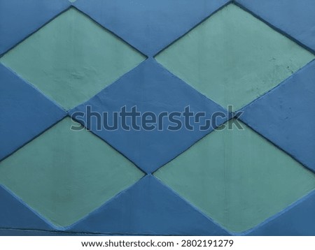 Blue and Green Diamond Pattern Texture on Painted Wall Background Photography