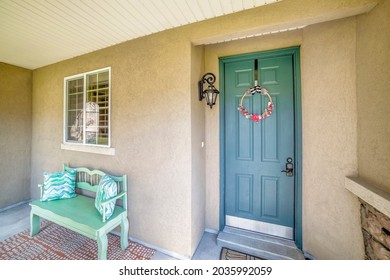 Blue green front door with wreath and digital entry access