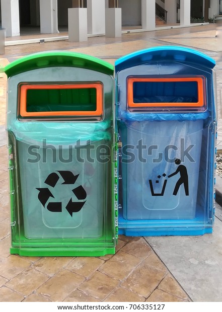 blue and\
green plastic bin seperate by garbage\
type