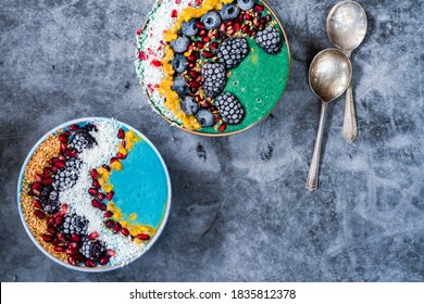 Blue And Green Spirulina Smoothie Bowls With Fruit And Linseed - Healthy Superfood Breakfast Idea. Overhead View