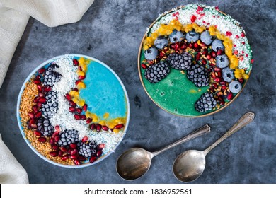 Blue And Green Spirulina Smoothie Bowls With Fruit And Linseed - Healthy Superfood Breakfast Idea. Overhead View