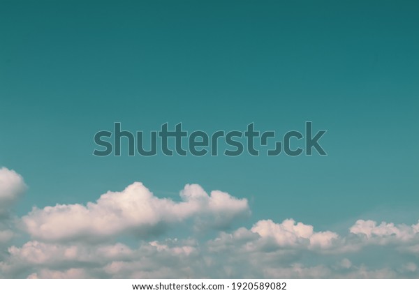blue and green turqouise sky and white clouds background 