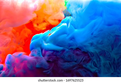 blue green yellow orange and pink colors melt in water - Shutterstock ID 1697625523