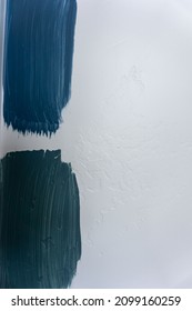 Blue Grey And Green Paint Swatches On A White Textured Wall