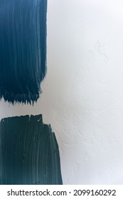 Blue Grey And Green Paint Swatches On A White Textured Wall