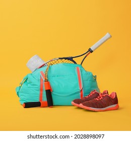 Blue gym bag and sports accessories on yellow background - Powered by Shutterstock