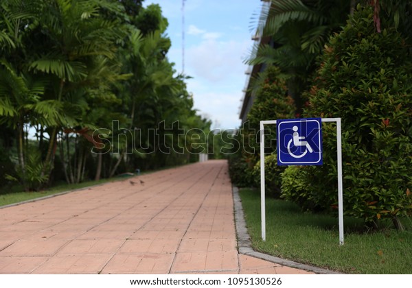 Blue Handicap sign or Disabled\
symbol it show the way for disable people in concept senior\
town