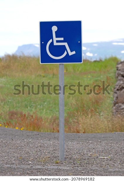 Blue handicapped parking sign for disabled\
drivers, Iceland