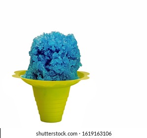 Blue Hawaiian Shave Ice, Shaved Ice Or A Snow Cone In A Yellow Flower Shaped Serving Cup.