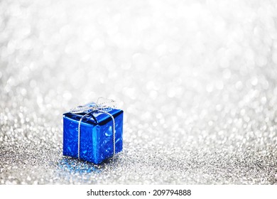 Blue Holiday Gift On Silver Glitter Background