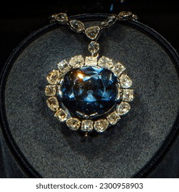A blue Hope Diamond necklace on a black background