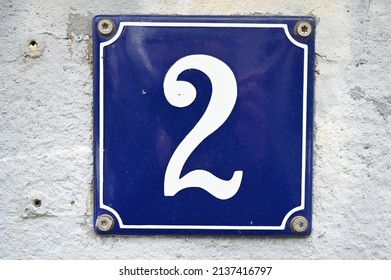 A blue house number plaque, showing the number two (number 2) 